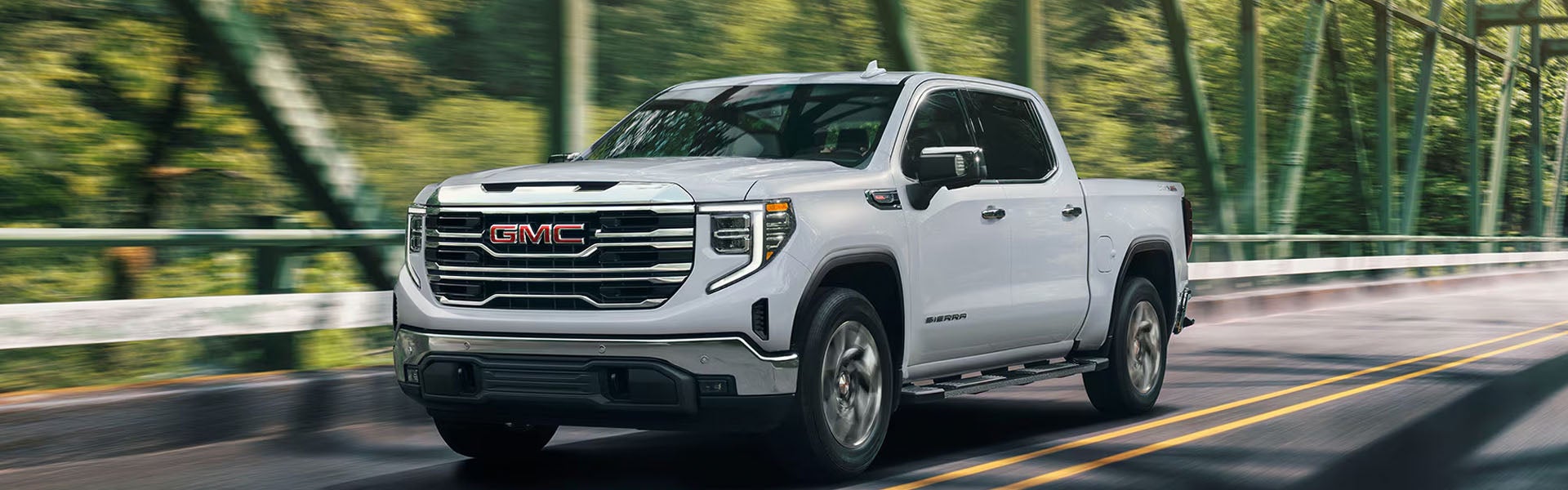 White GMC Sierra 1500 driving road